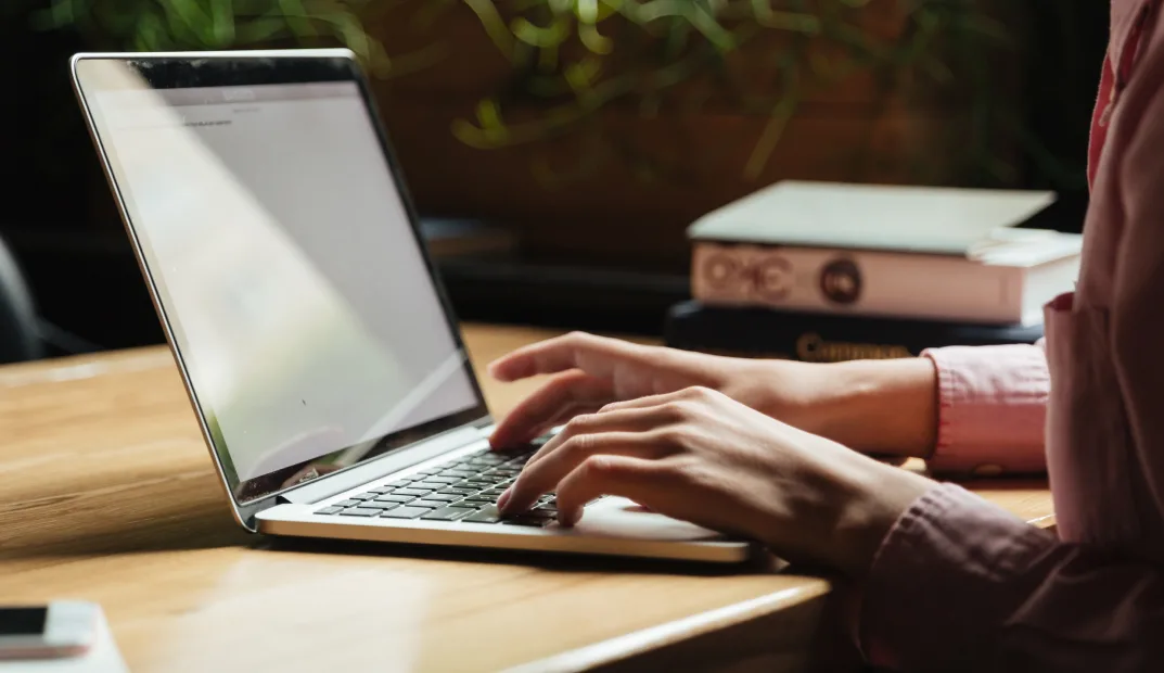 Person submitting a referral from a laptop at a desk
