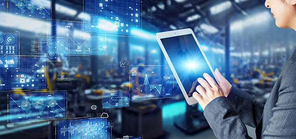Person using tablet with data analytics visuals in modern factory setting.